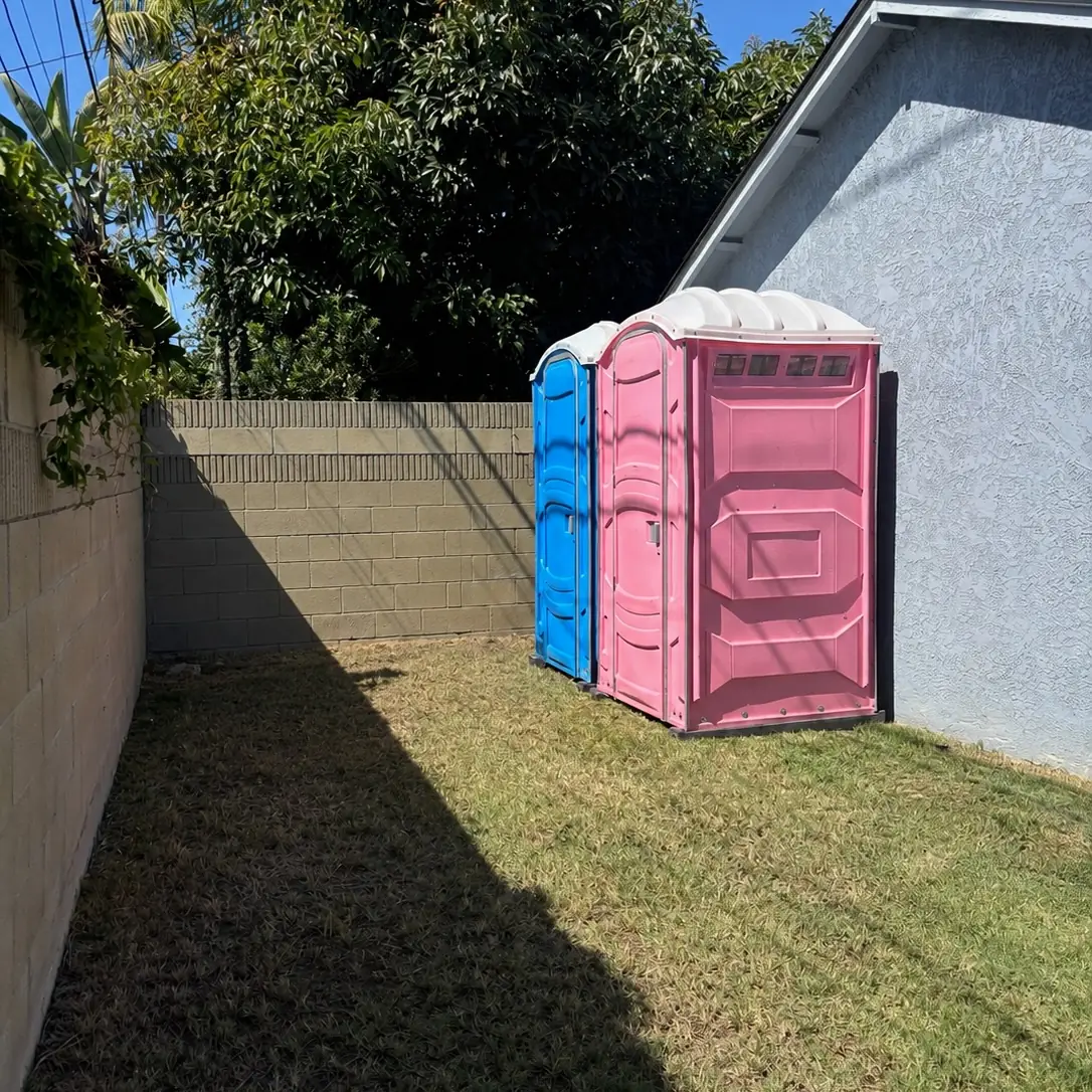 Porta potties on a backyard lawn