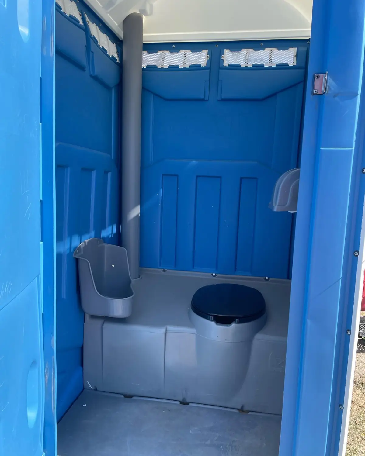 Clean blue interior of a standard porta potty